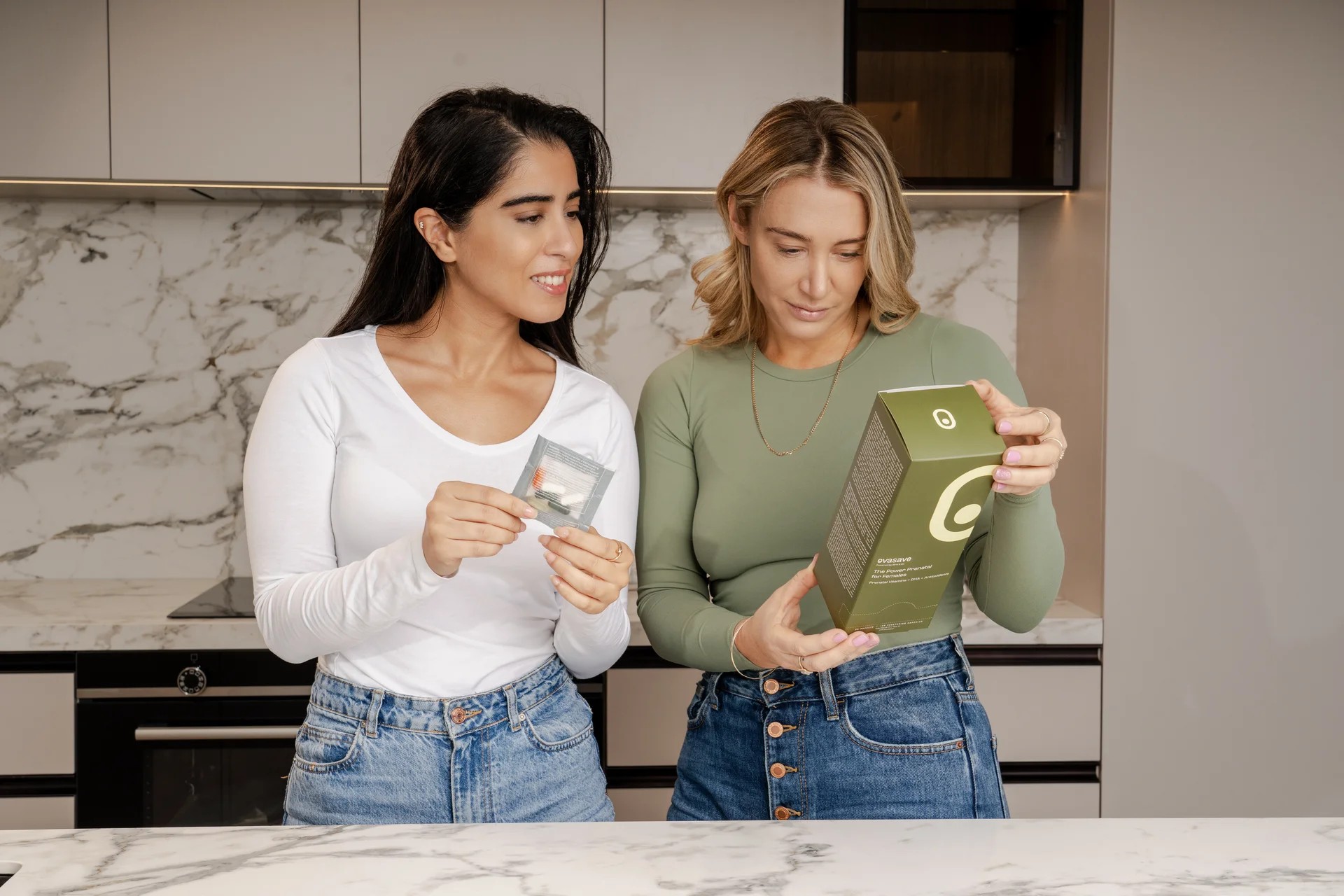 Two women looking at supplement packaging